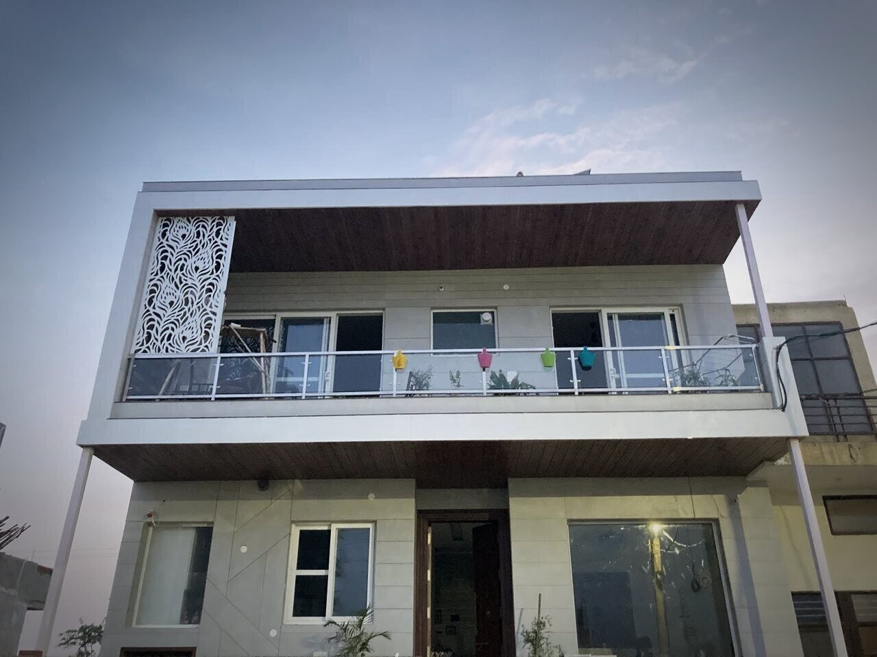 House façade with a laser-cut jaali screen and glass balcony